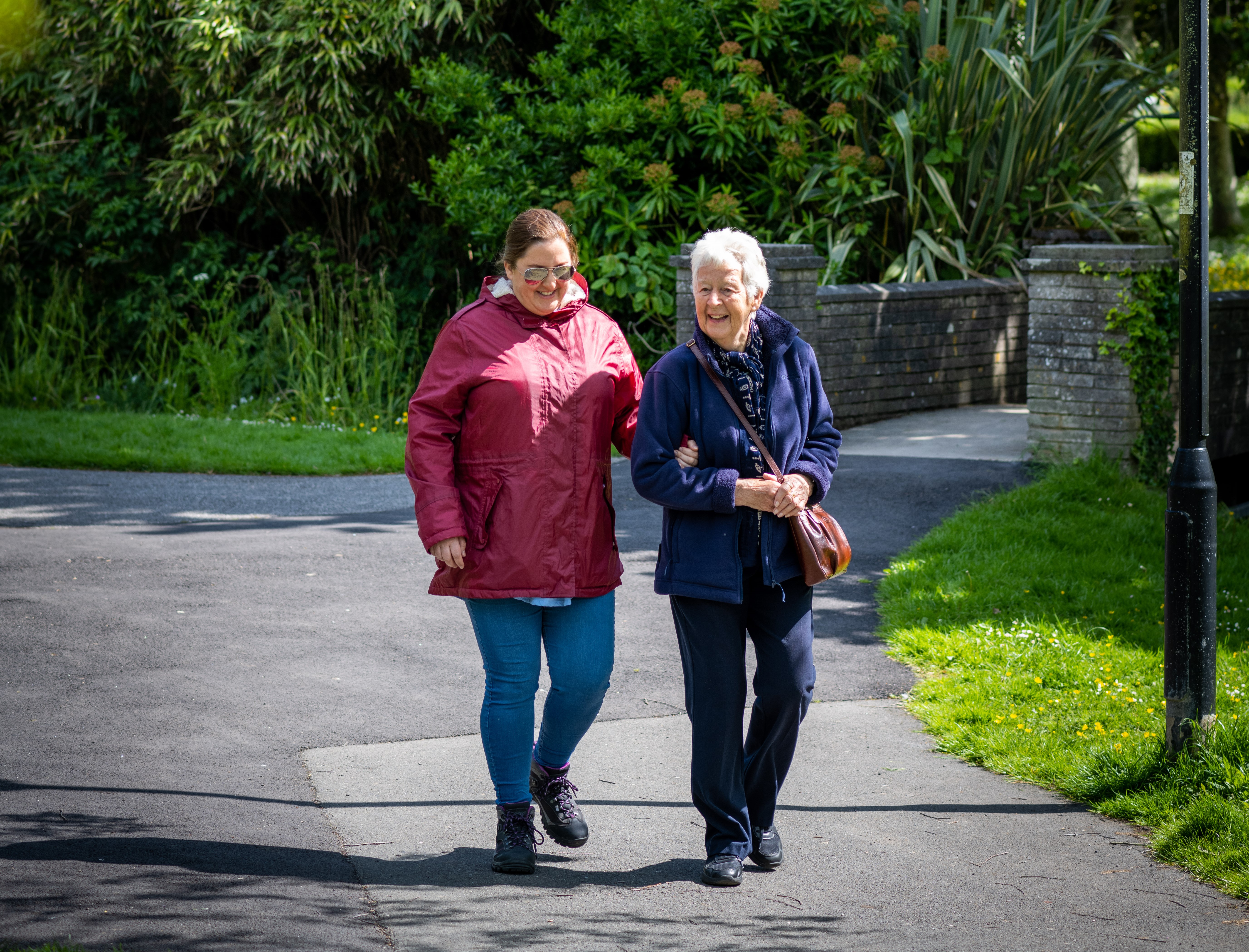 Walking Buddies, volunteer guiding a visually impaired client 