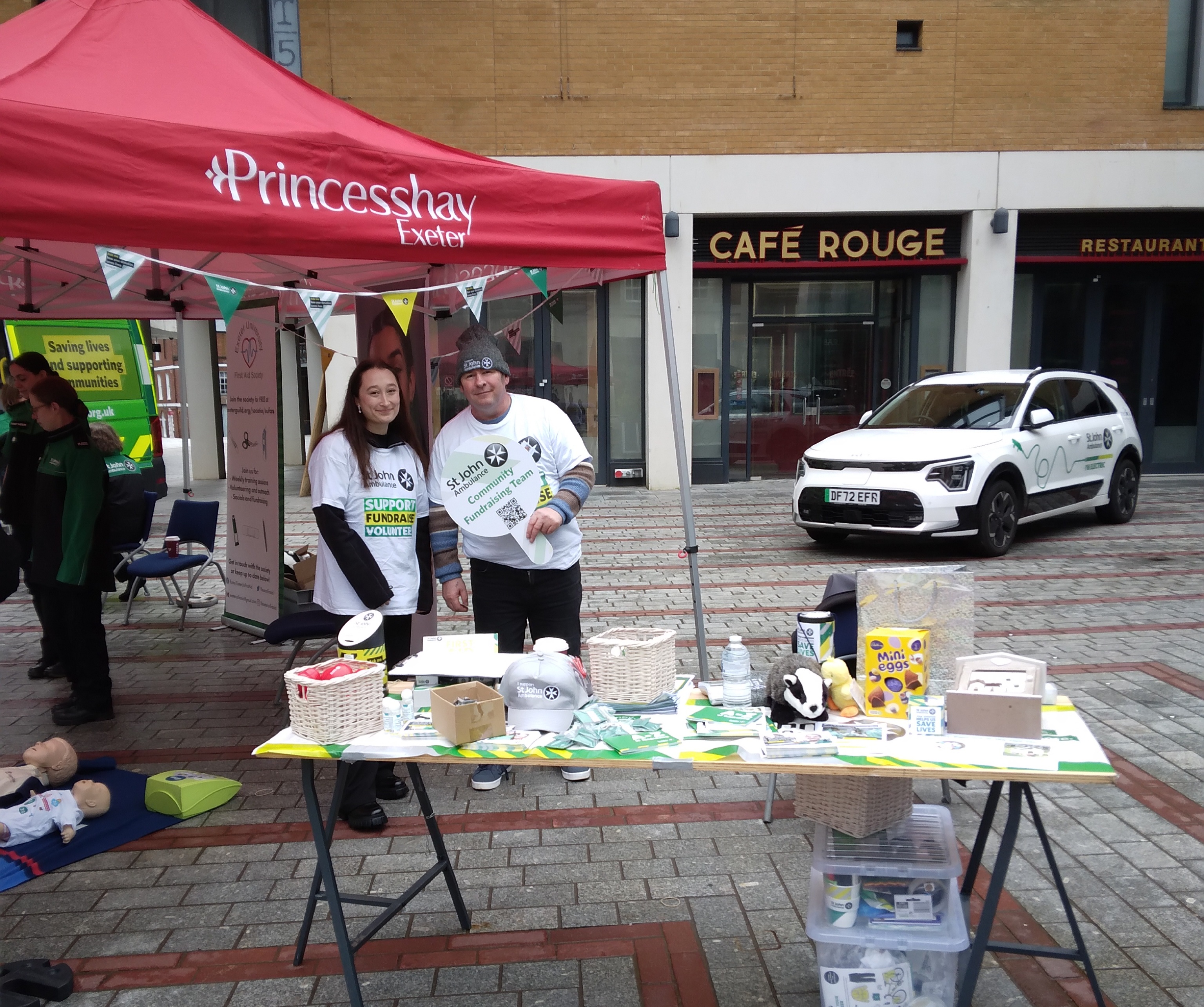 photo of a community fundraising stand with two volunteers