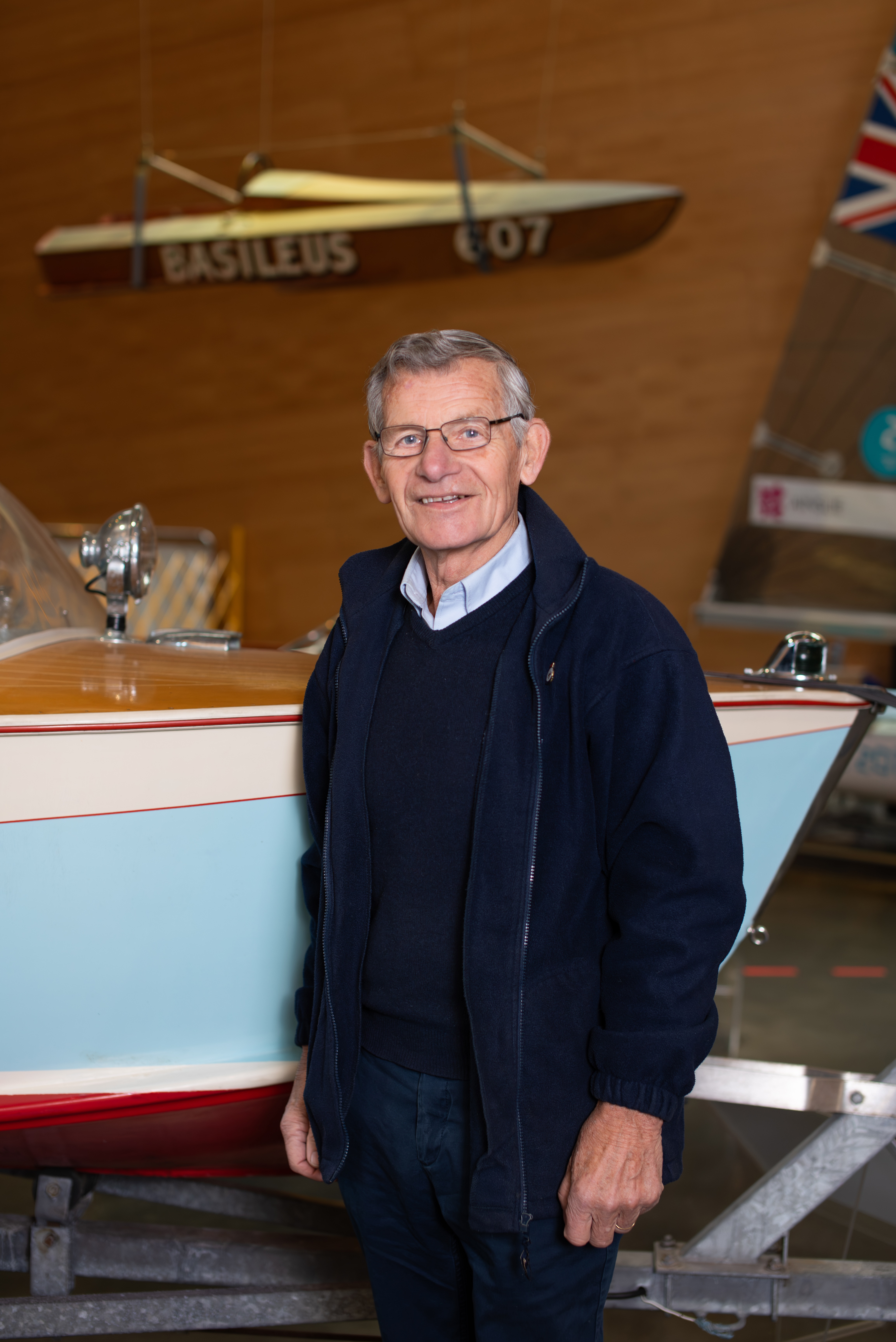 National Maritime Museum Cornwall Volunteer stood next to an exhibit boat in the Boat Hall