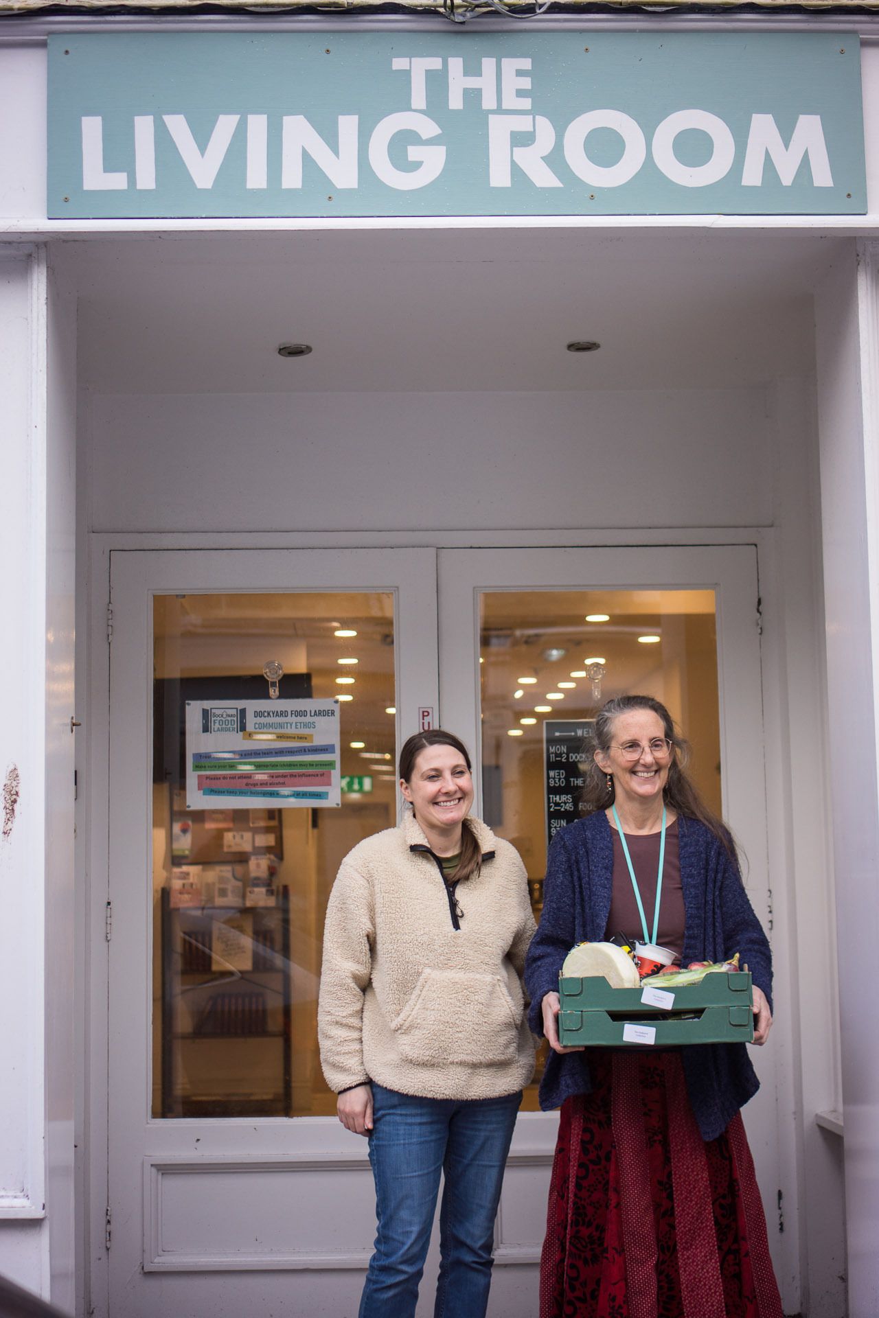 Photo of food people holding boxes of food. 