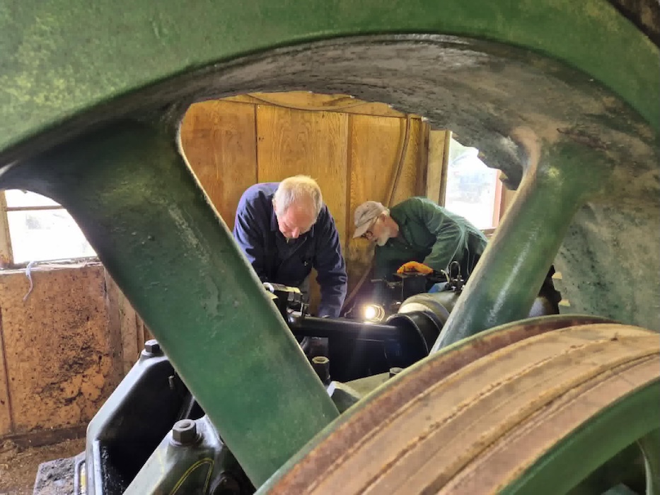 Image shows two members working on the Ruston Hornsby engine at Nance saw mills