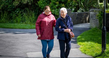 Walking Buddies, volunteer guiding a visually impaired client 