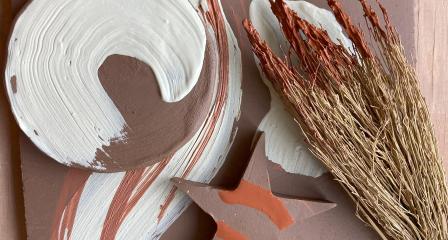 A Leach Pottery workshop materials with a plate, a star and a natural paintbrush from foliage.