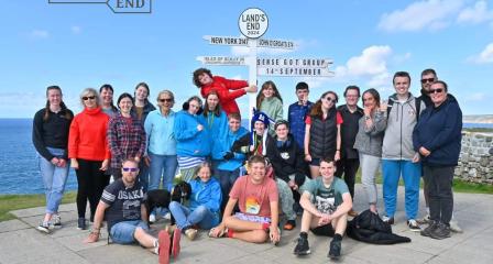 Picture of our young people at land's end. They are all standing next to the land's end sign and smiling.