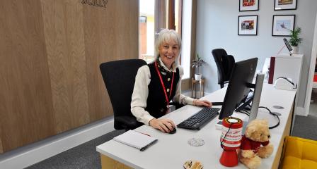 Reception volunteer at desk 